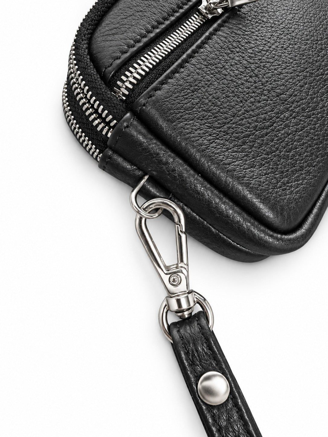Close-up of the black pouch's textured surface, stitching and wrist-strap clip.