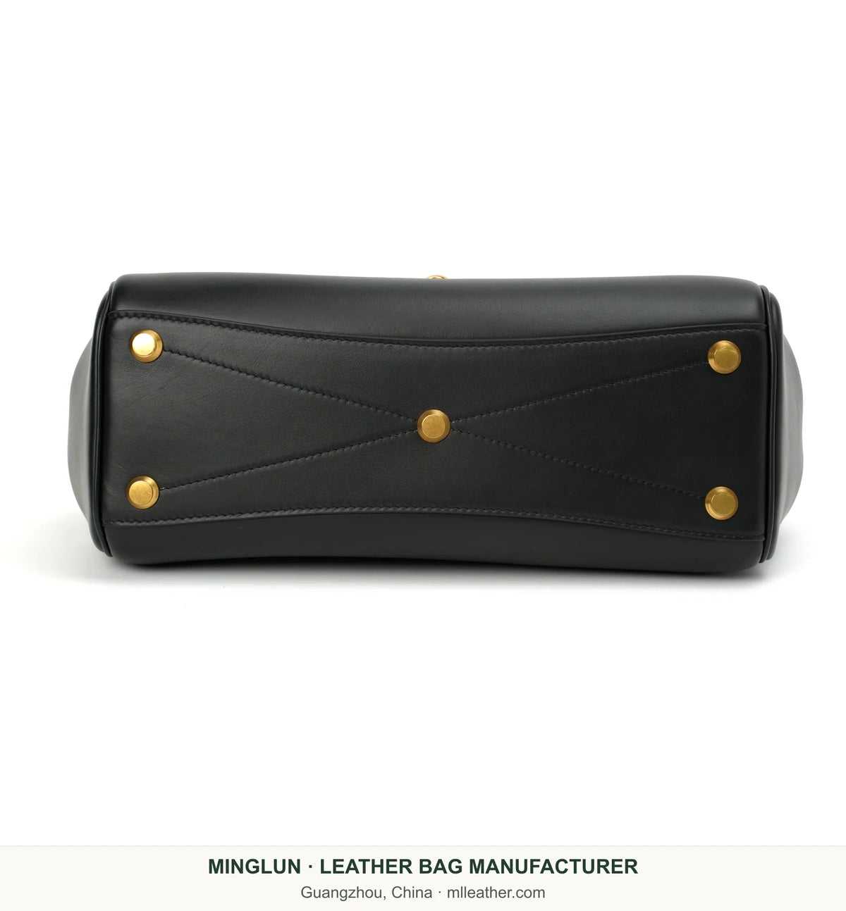 Base of black calfskin tote showing five gold-tone feet. MINGLUN manufacturer watermark at the bottom.