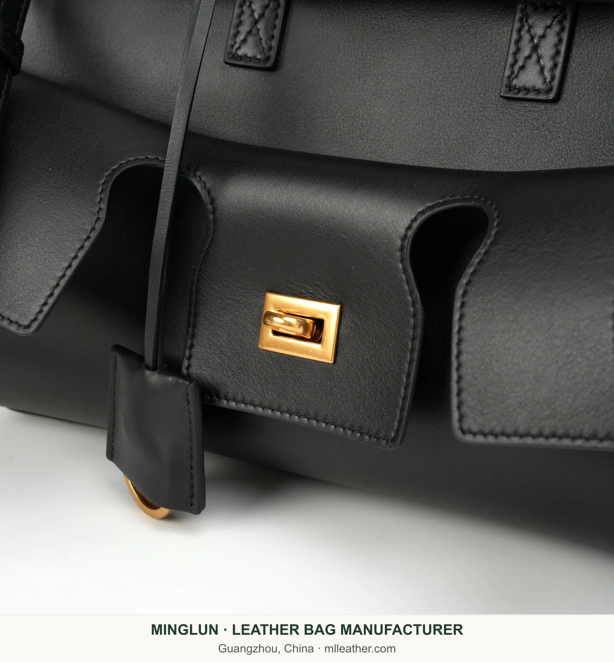 Close-up of front pocket, stitching and gold-tone turn lock. MINGLUN manufacturer watermark at the bottom.