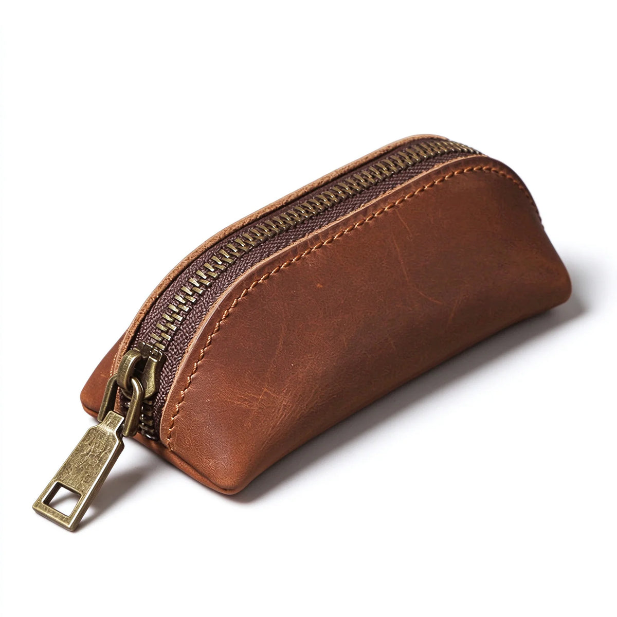 Brown leather zip key pouch with contrast stitching and an antique-brass-tone zipper, front angled view.