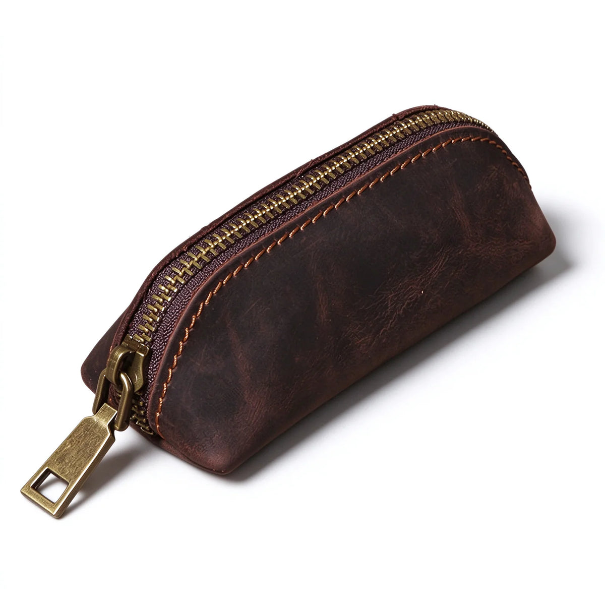 Dark brown leather key pouch with contrast stitching and an antique-brass-tone zipper, front angled view.