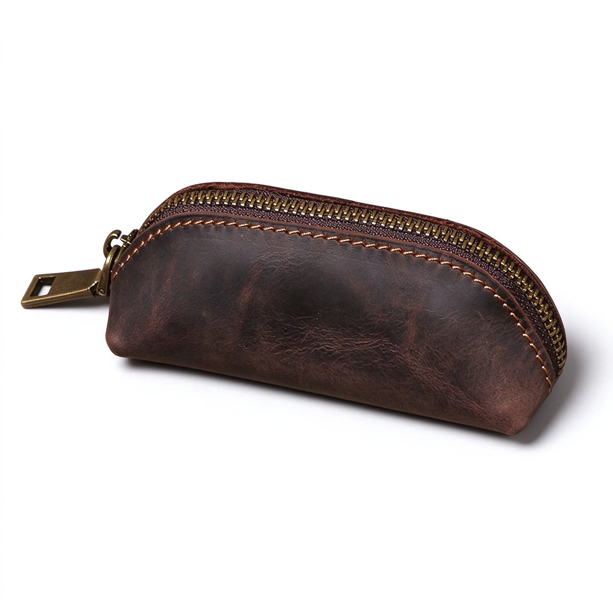 Side view of a dark brown leather zip key pouch showing its curved profile and stitched seam.