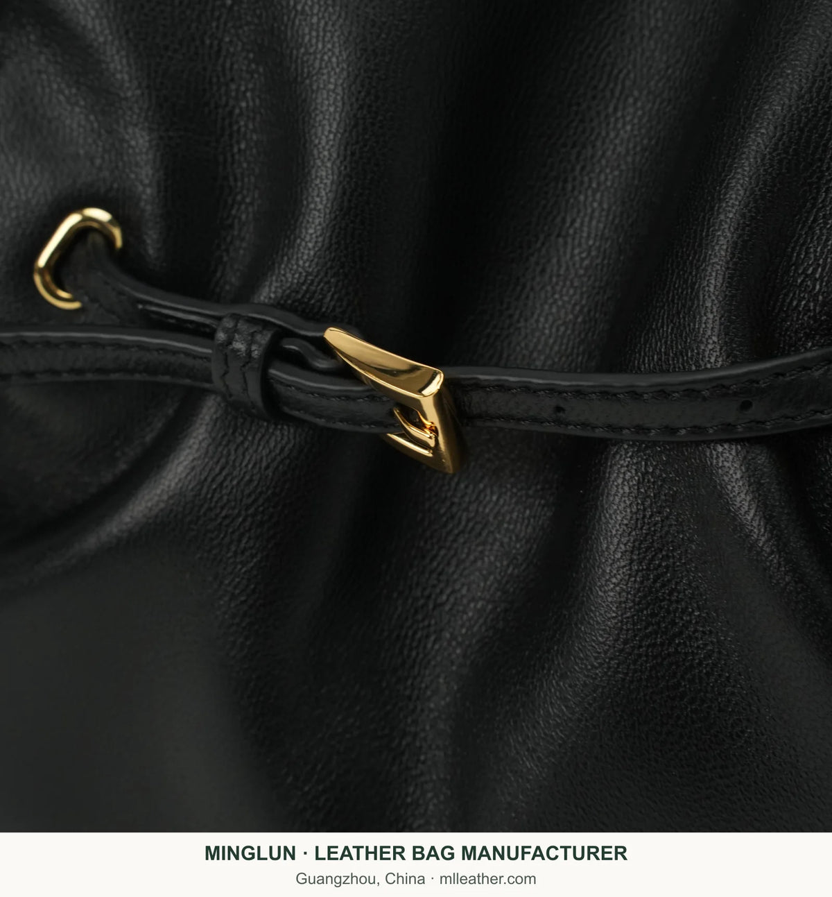 Gold-tone buckle and leather strap detail on black sheepskin tote bag. MINGLUN manufacturer watermark at the bottom.