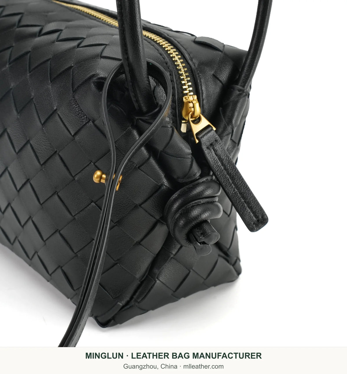 Gold-tone zipper and side knot on black handwoven sheepskin bag. MINGLUN manufacturer watermark at the bottom.