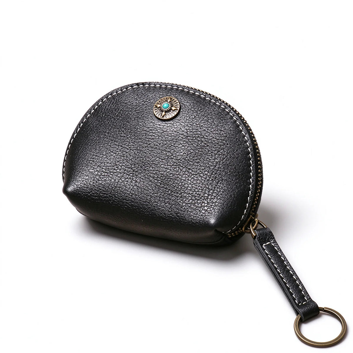 Angled view of a black leather key pouch showing contrast stitching and the attached key-ring tab