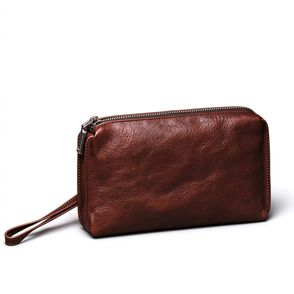 Red-brown leather long wallet and phone wristlet with a matching wrist loop on a white background