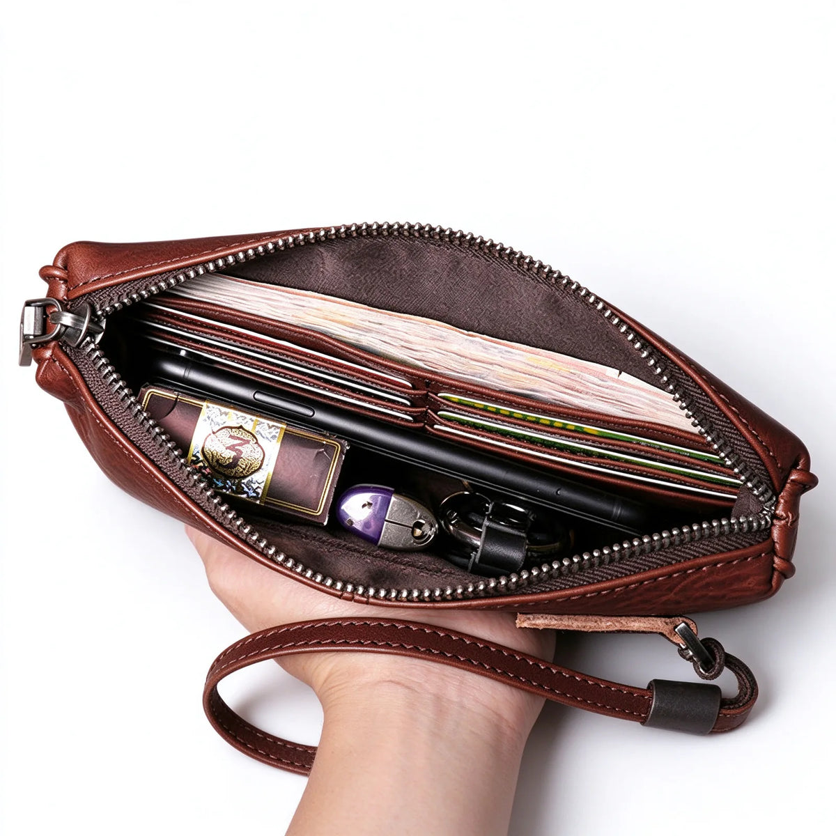 Open red-brown leather long wallet showing card slots, banknotes, a phone and keys