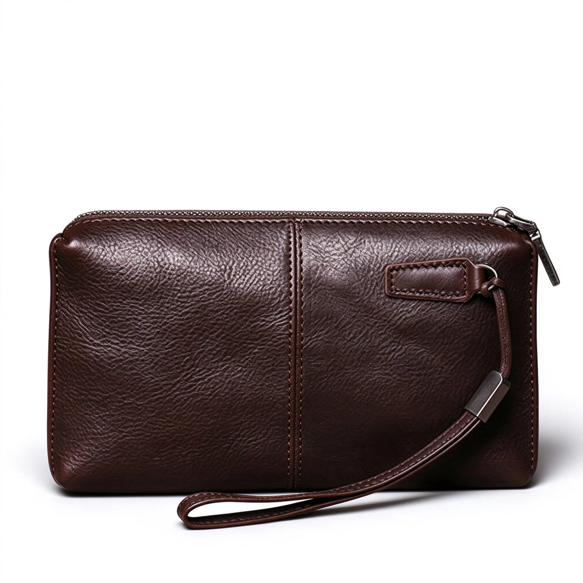 Reverse side of a dark brown leather wristlet showing its central seam and stitched strap tab