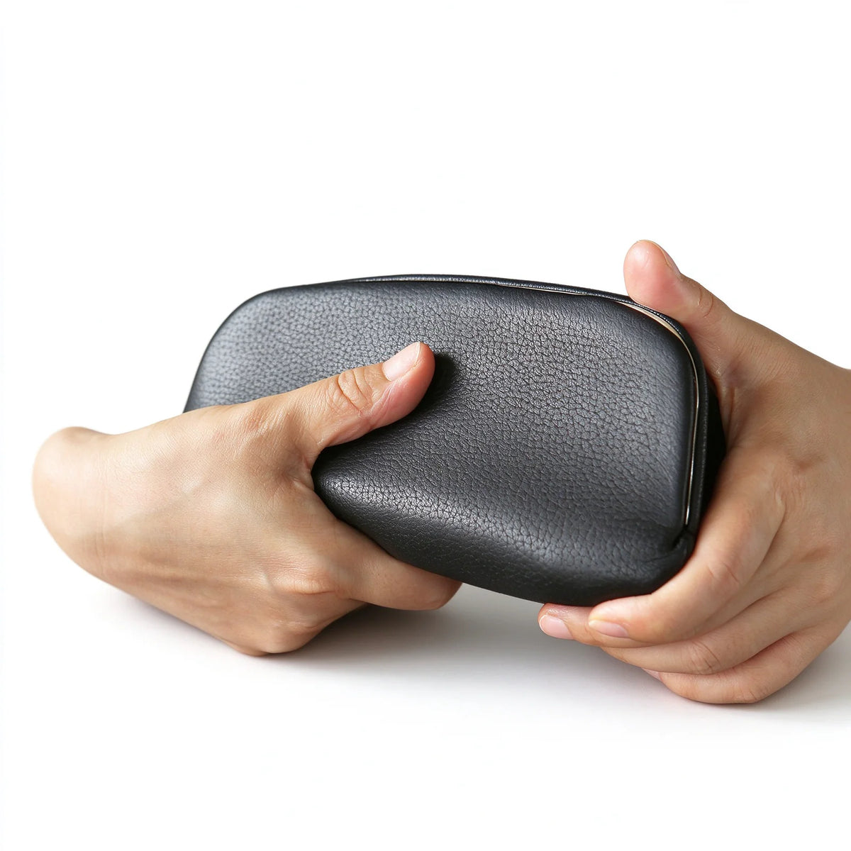 Black leather metal-frame clutch pouch held in both hands to show its rounded shape