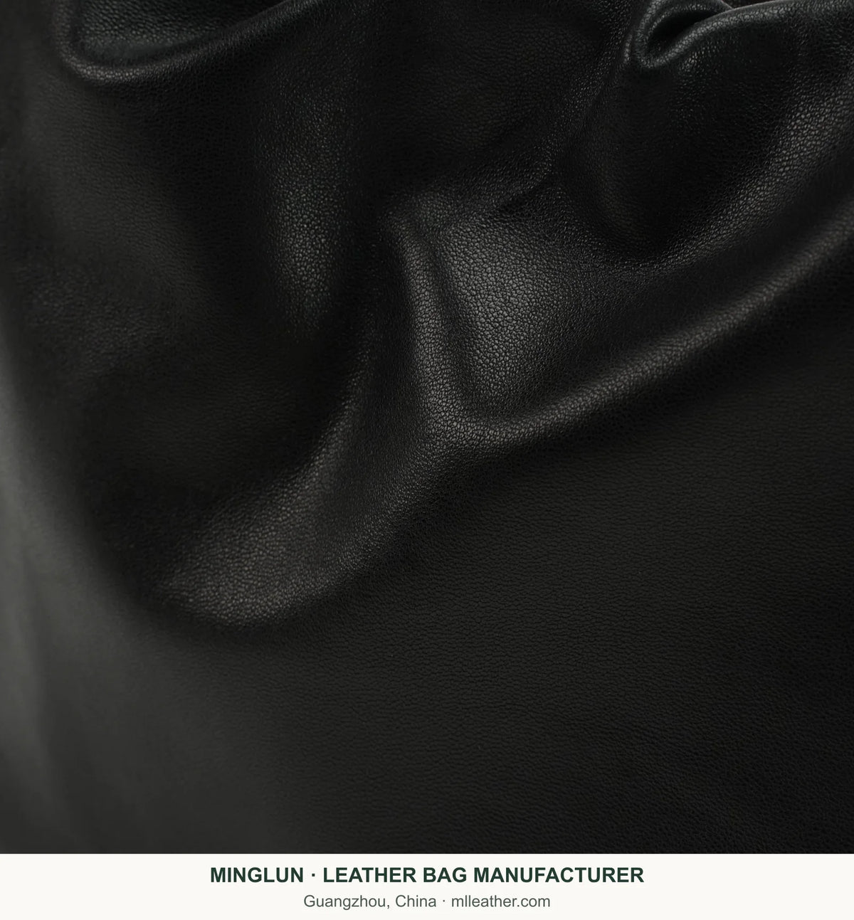 Gathered black sheepskin texture detail on shoulder bag. MINGLUN manufacturer watermark at the bottom.