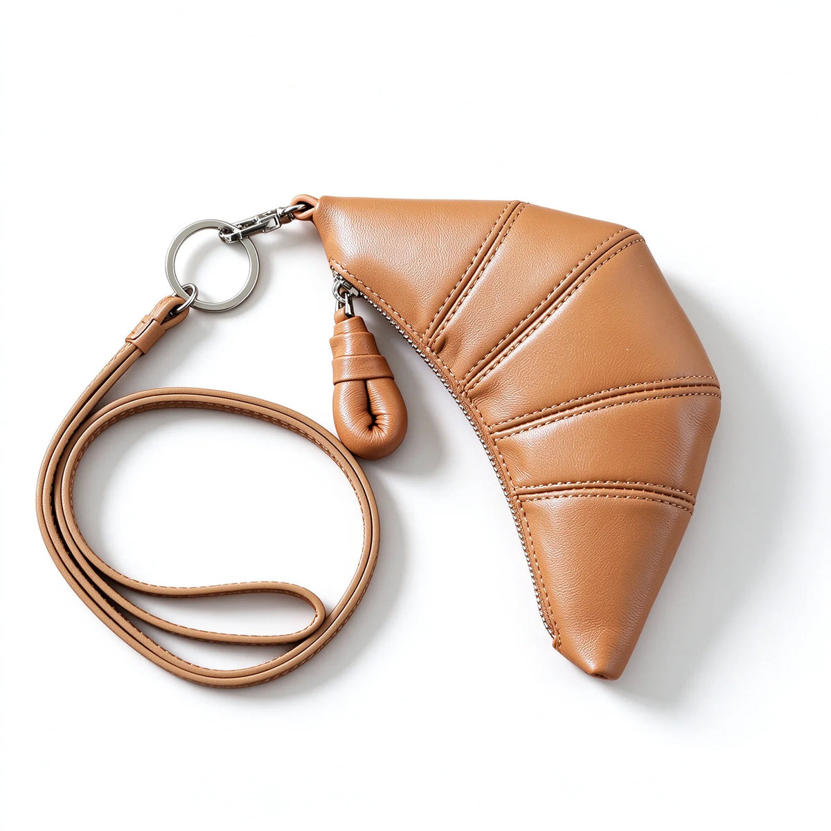 Tan crescent leather pouch with a matching clip-on strap, silver-tone ring and rounded leather zip pull.