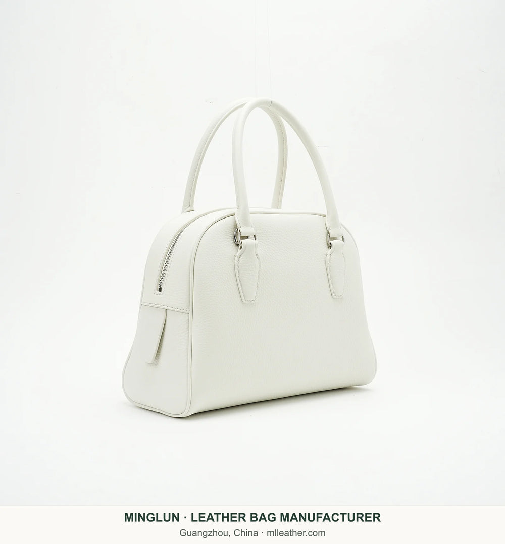 Ivory top-grain cowhide bowling bag, three-quarter view. MINGLUN manufacturer watermark at the bottom.
