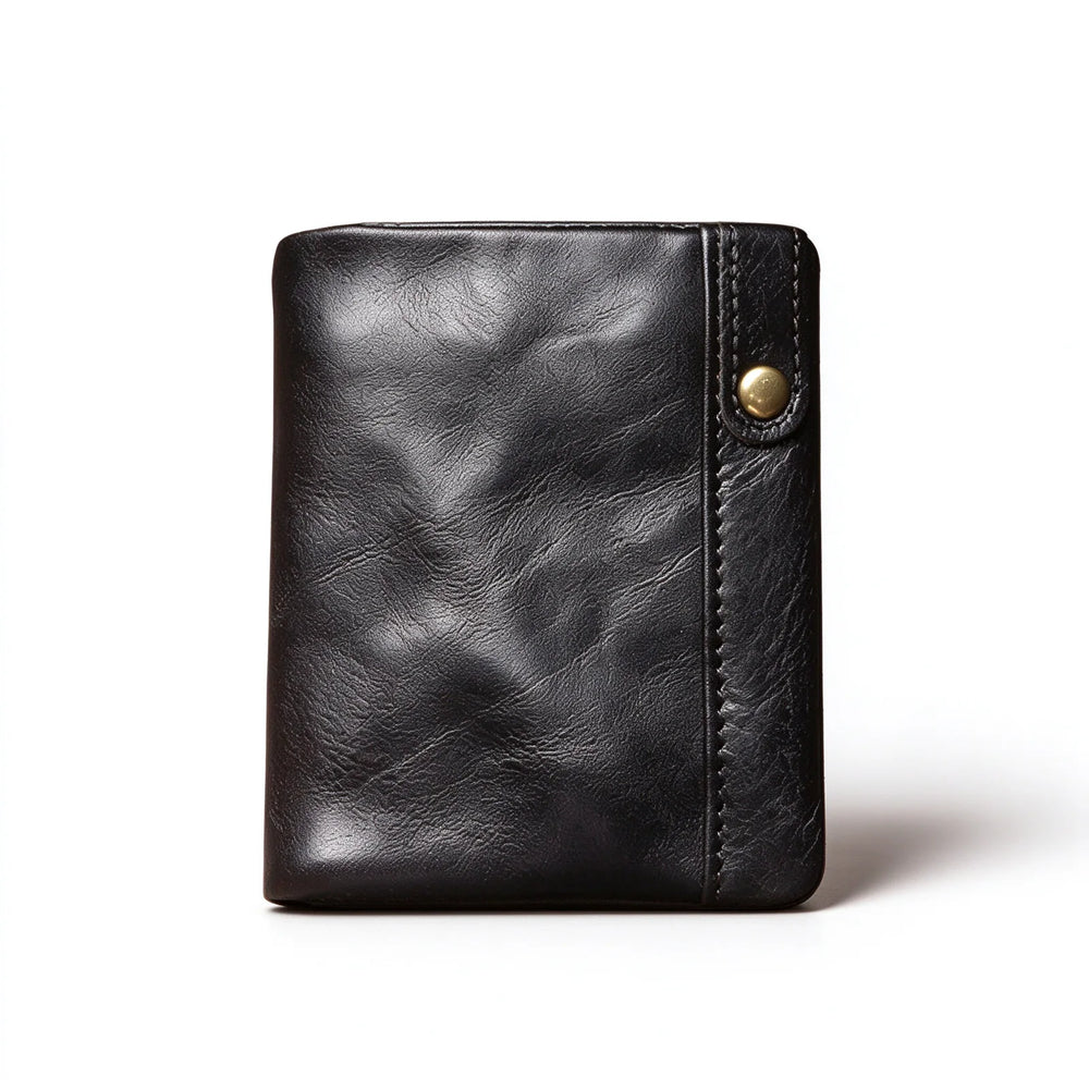 Black leather card and coin wallet standing upright with a slim snap-fastened tab on the front edge.