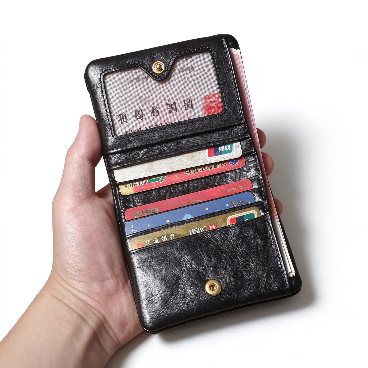 Open black leather wallet holding cards and banknotes, with an identification window above the card slots.