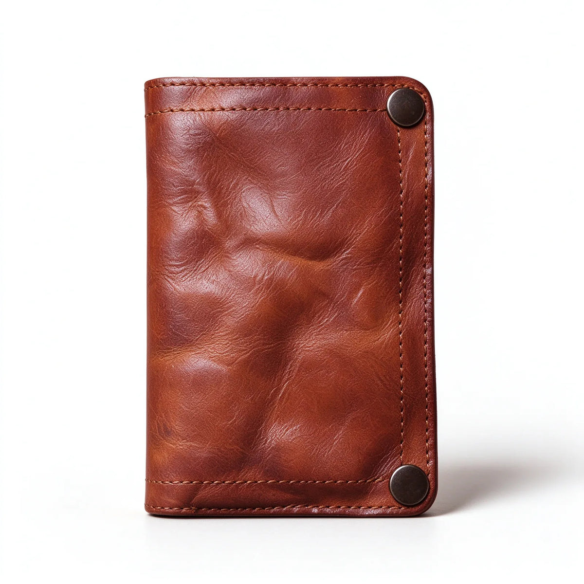 Brown leather bifold wallet standing upright with two corner snap fasteners and visible edge stitching.